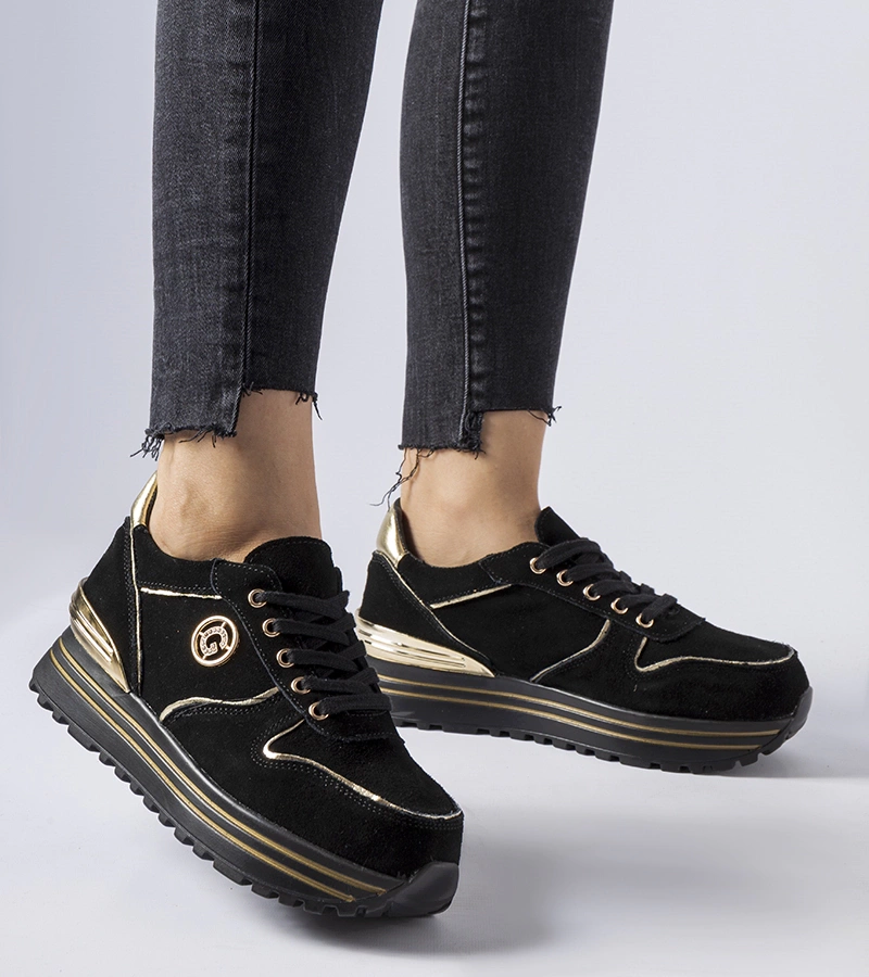 Skórzane czarne sneakersy zdobione złotą lamówką